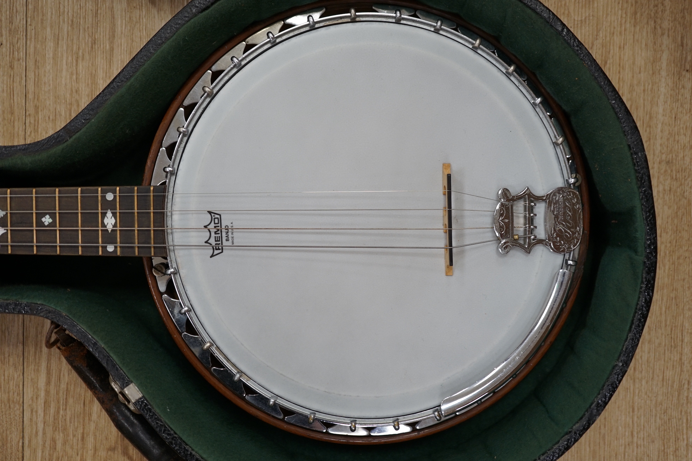 A cased English 1930s Windsor Whirl four string tenor banjo, mother of pearl inlaid neck, length of body 33cm, overall length 84cm, in fitted case